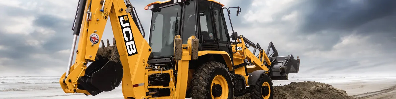 Retroescavadeira amarela da JCB trabalhando em um terreno arenoso