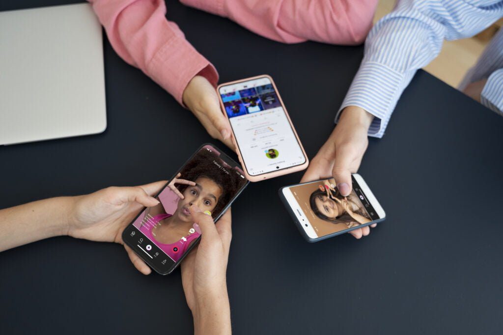 high-angle-hands-holding-smartphones